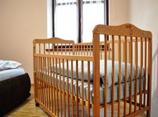 Bedroom with a baby cot